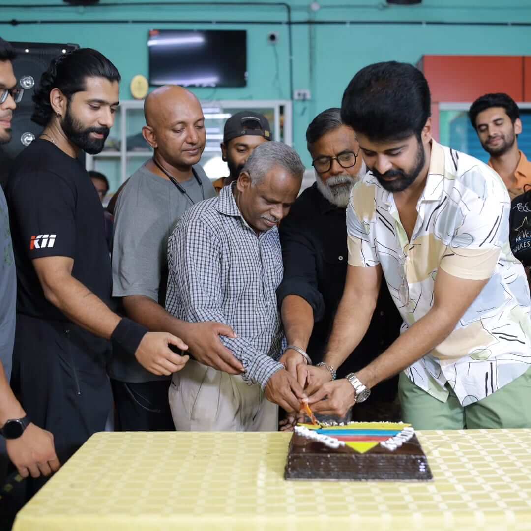 Fitness celebration at the gym with trainers and members cutting a cake to commemorate success