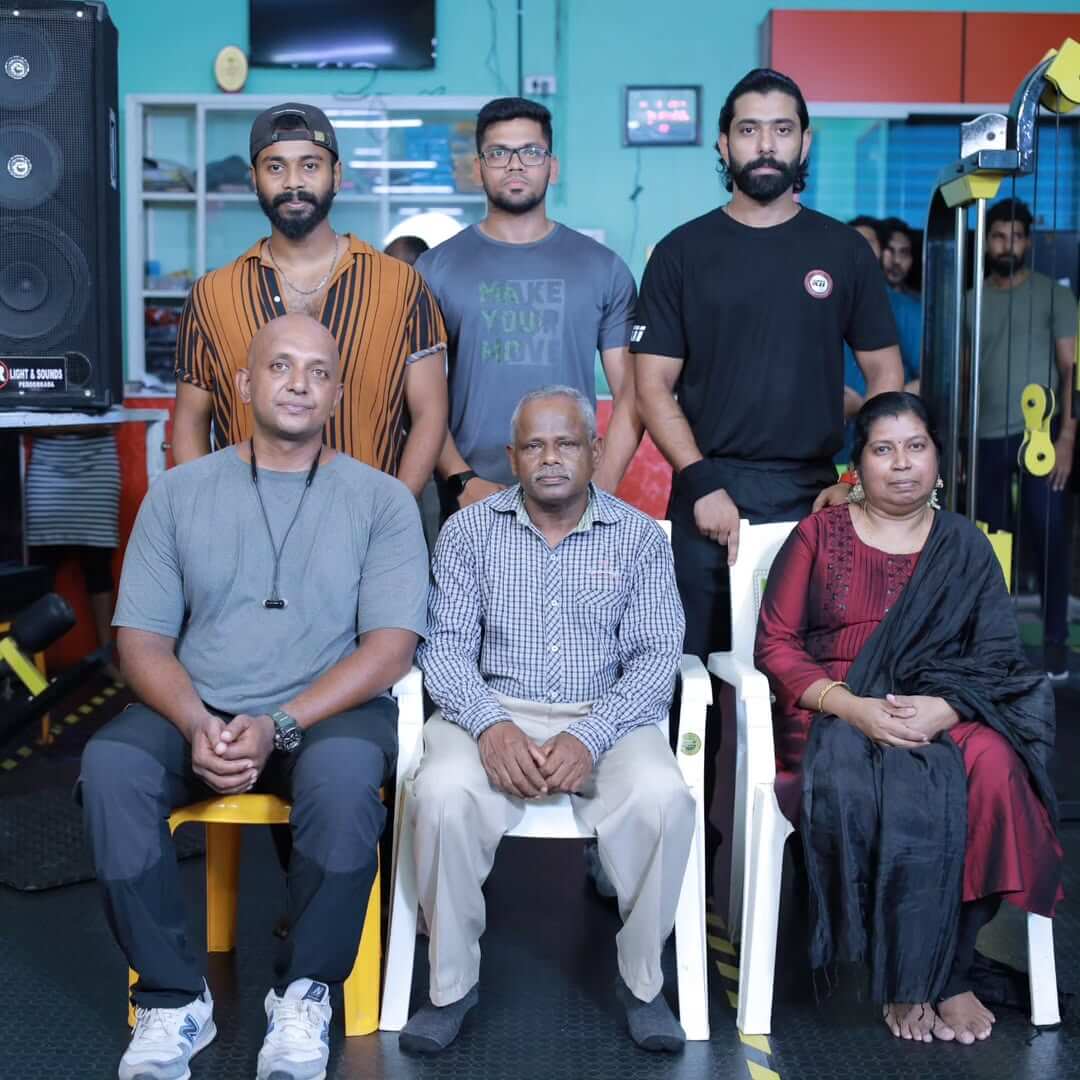Fitness celebration at the gym with trainers and members cutting a cake to commemorate success