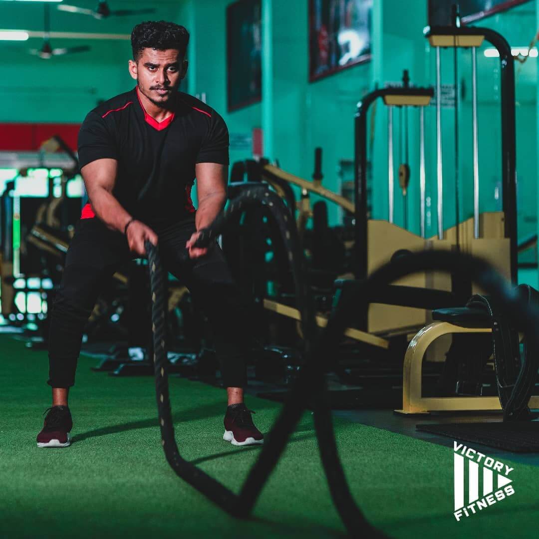 Individual performing a deadlift in the gym to enhance core and leg strength