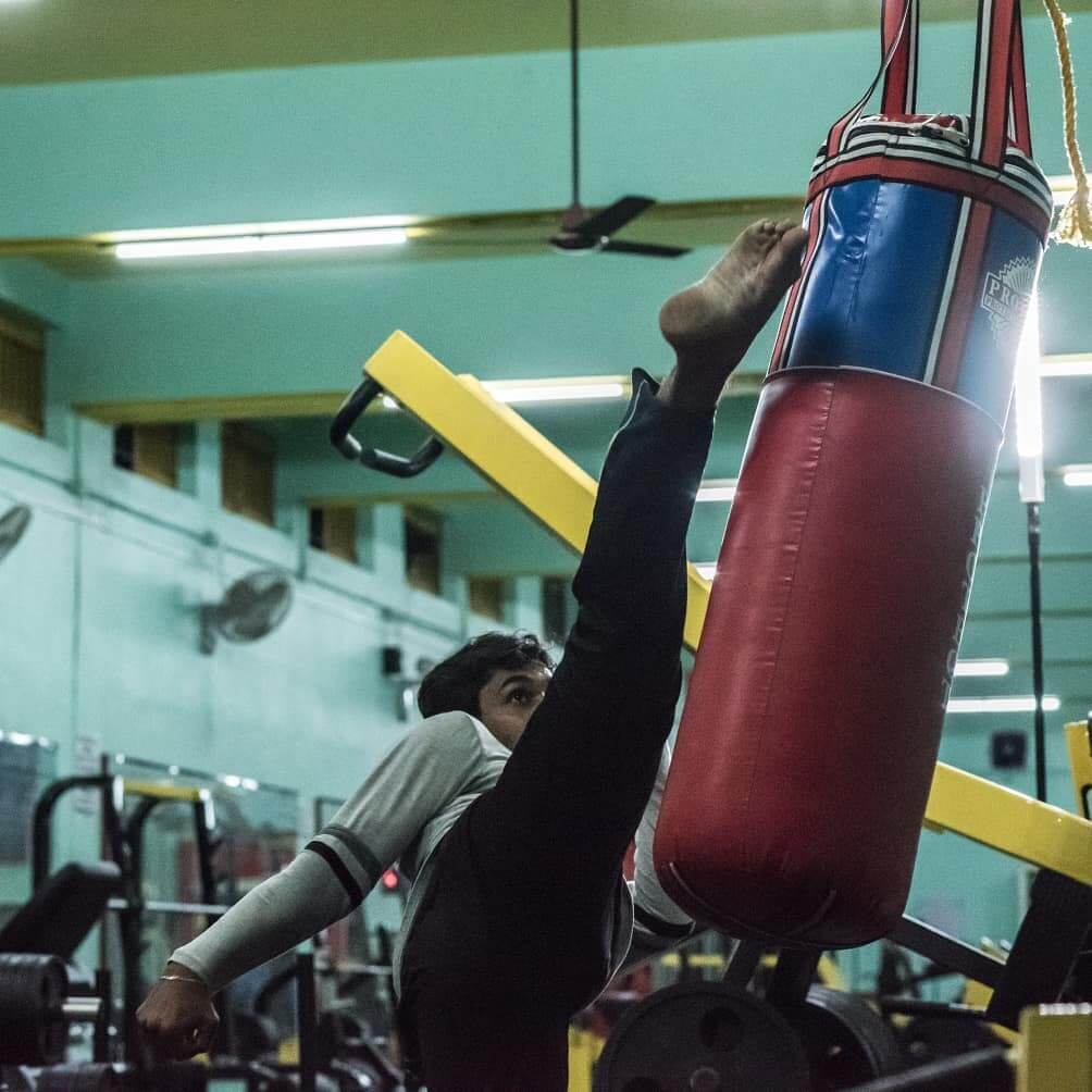 Person lifting weights at the gym, building strength and muscle