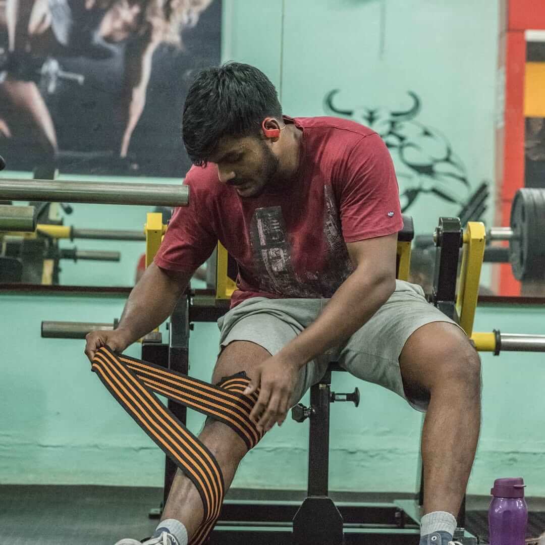Person lifting weights at the gym, building strength and muscle