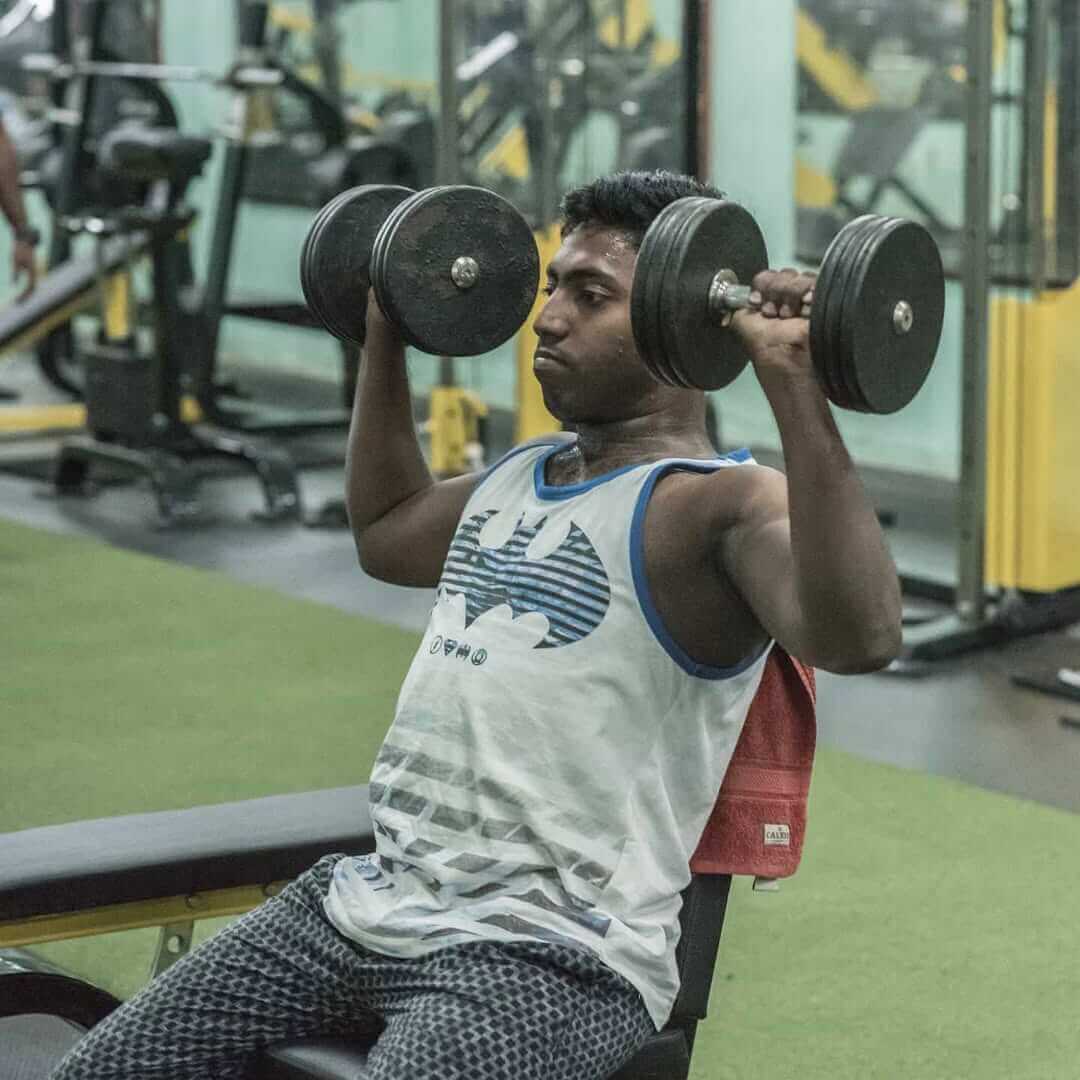 Individual performing a deadlift in the gym to enhance core and leg strength