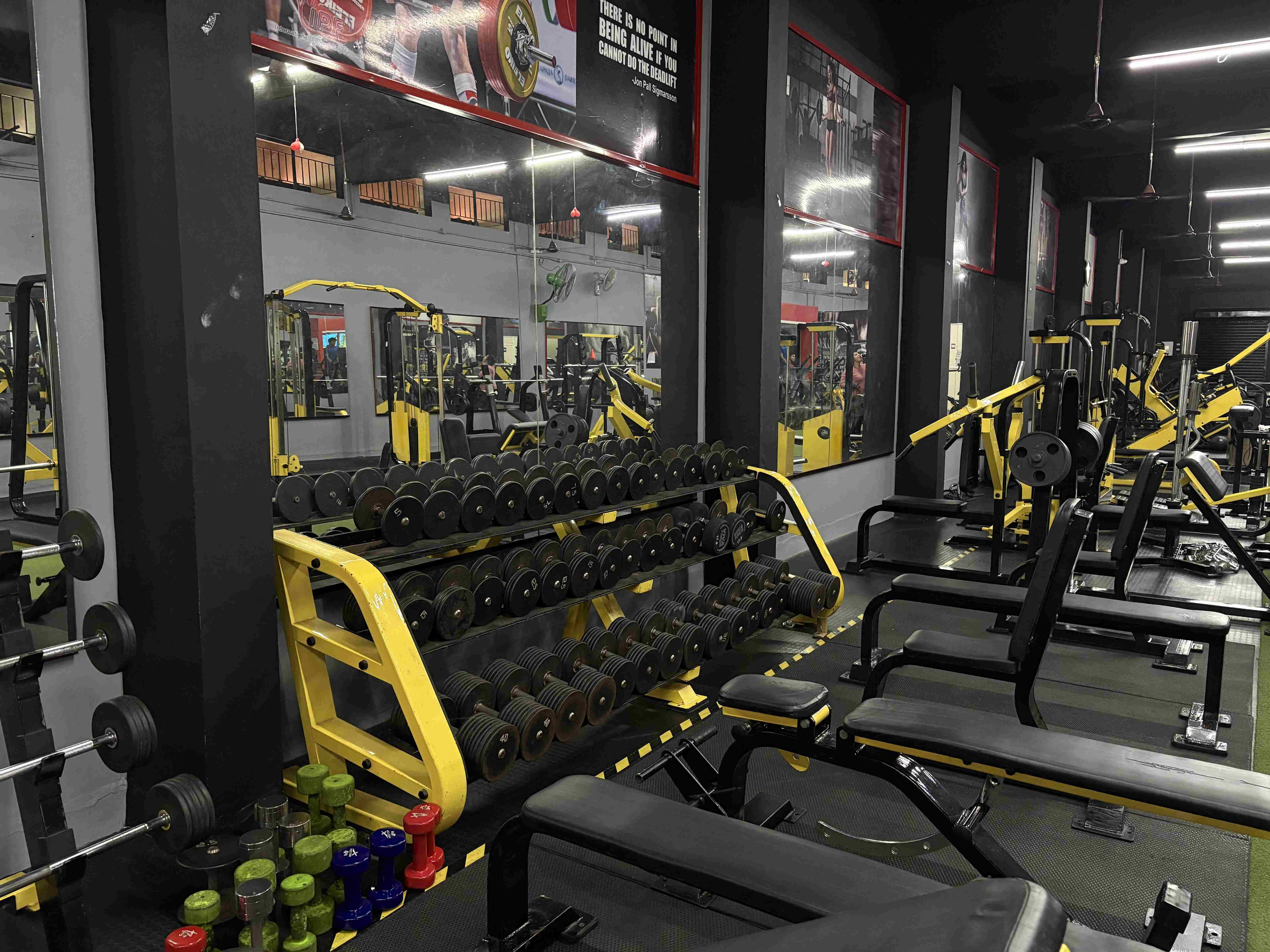 Individual performing a deadlift in the gym to enhance core and leg strength