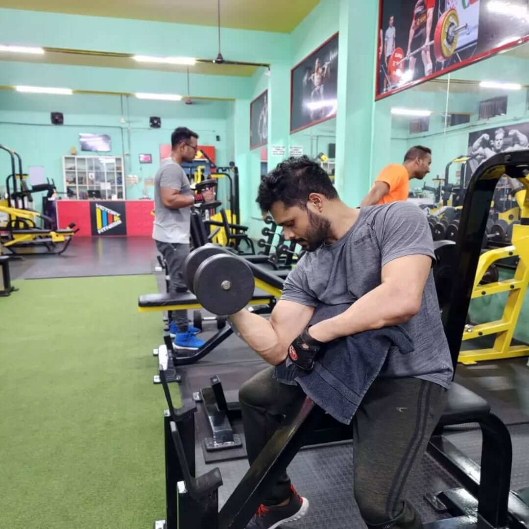 Individual performing a deadlift in the gym to enhance core and leg strength