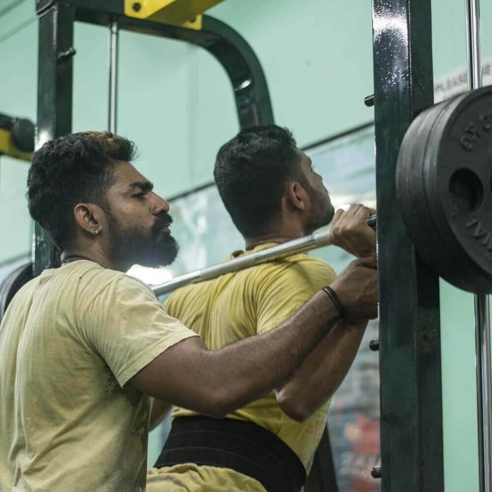 Individual performing a deadlift in the gym to enhance core and leg strength