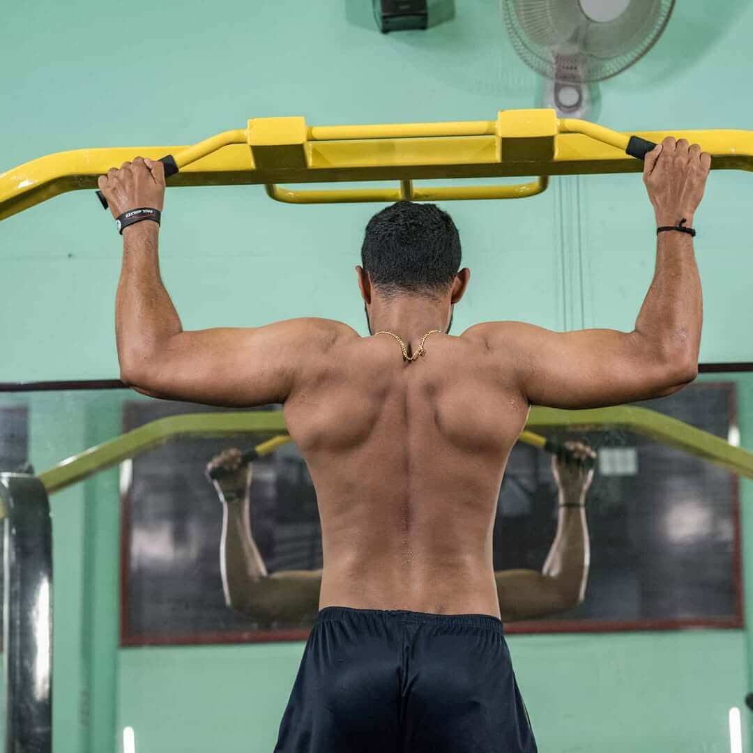 Individual performing a deadlift in the gym to enhance core and leg strength