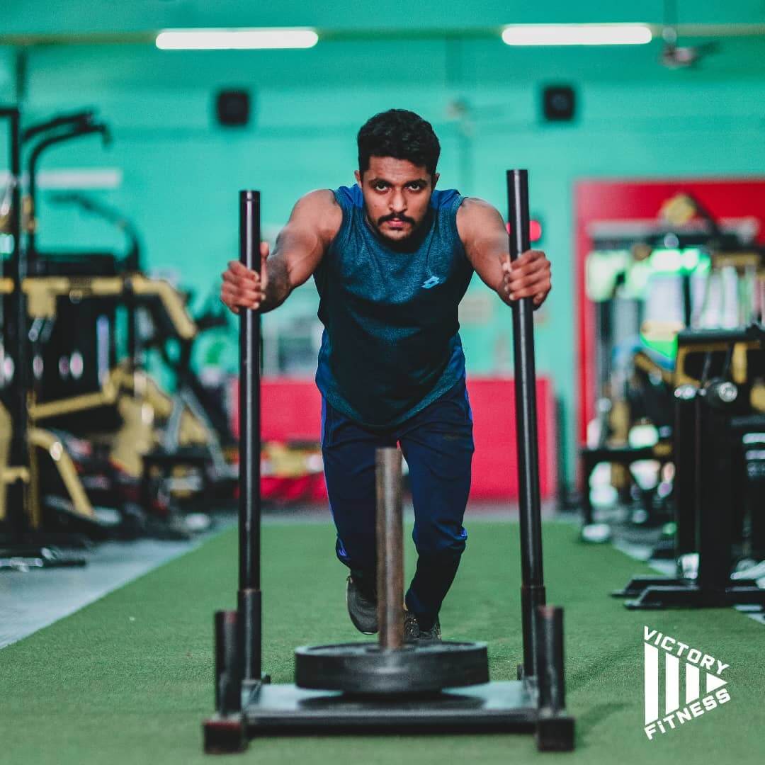 Individual performing a deadlift in the gym to enhance core and leg strength