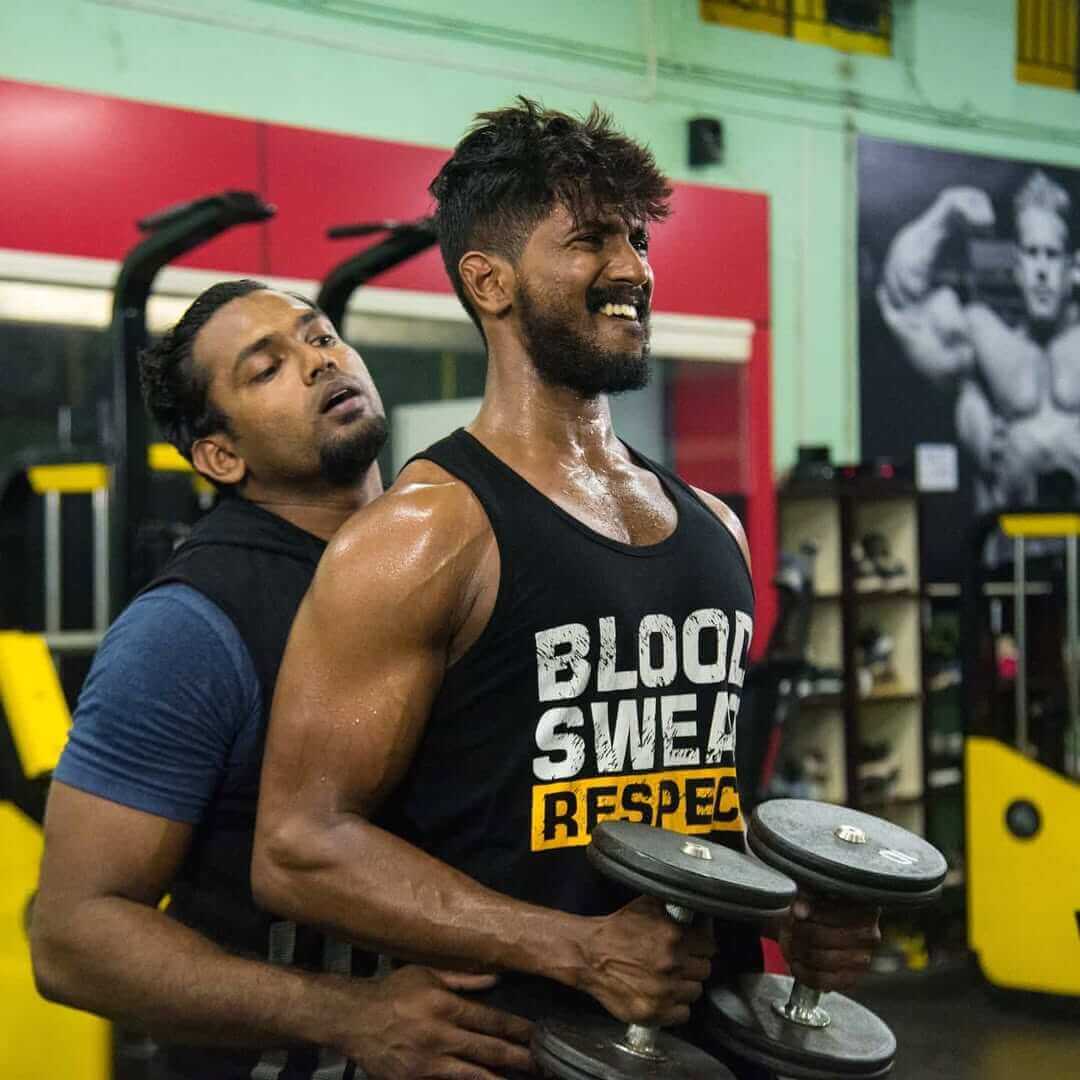 Person lifting weights at the gym, building strength and muscle