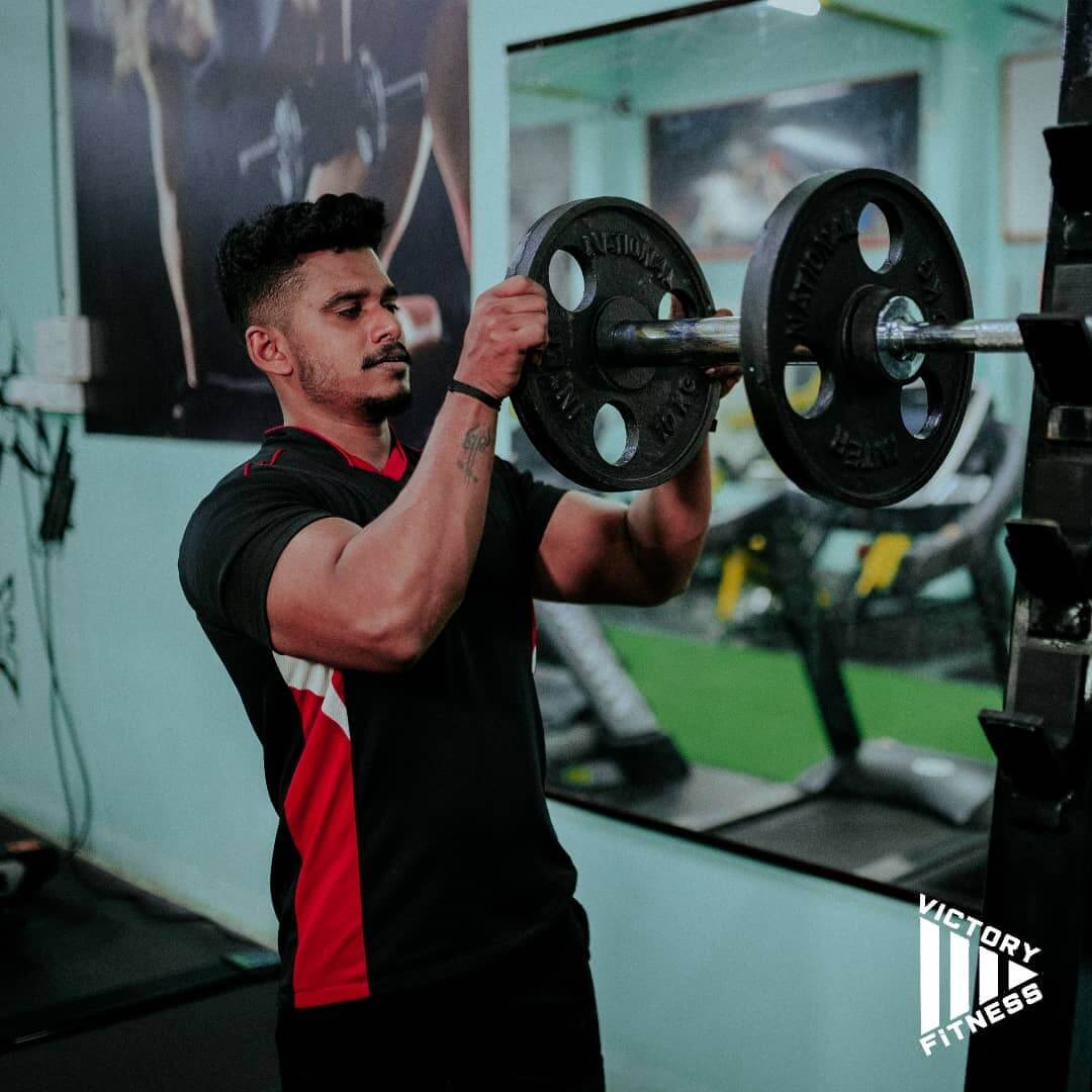 Individual performing a deadlift in the gym to enhance core and leg strength