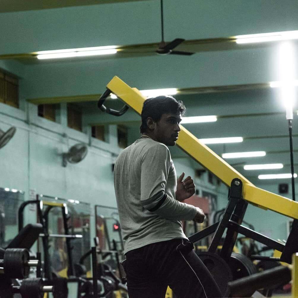 Person lifting weights at the gym, building strength and muscle