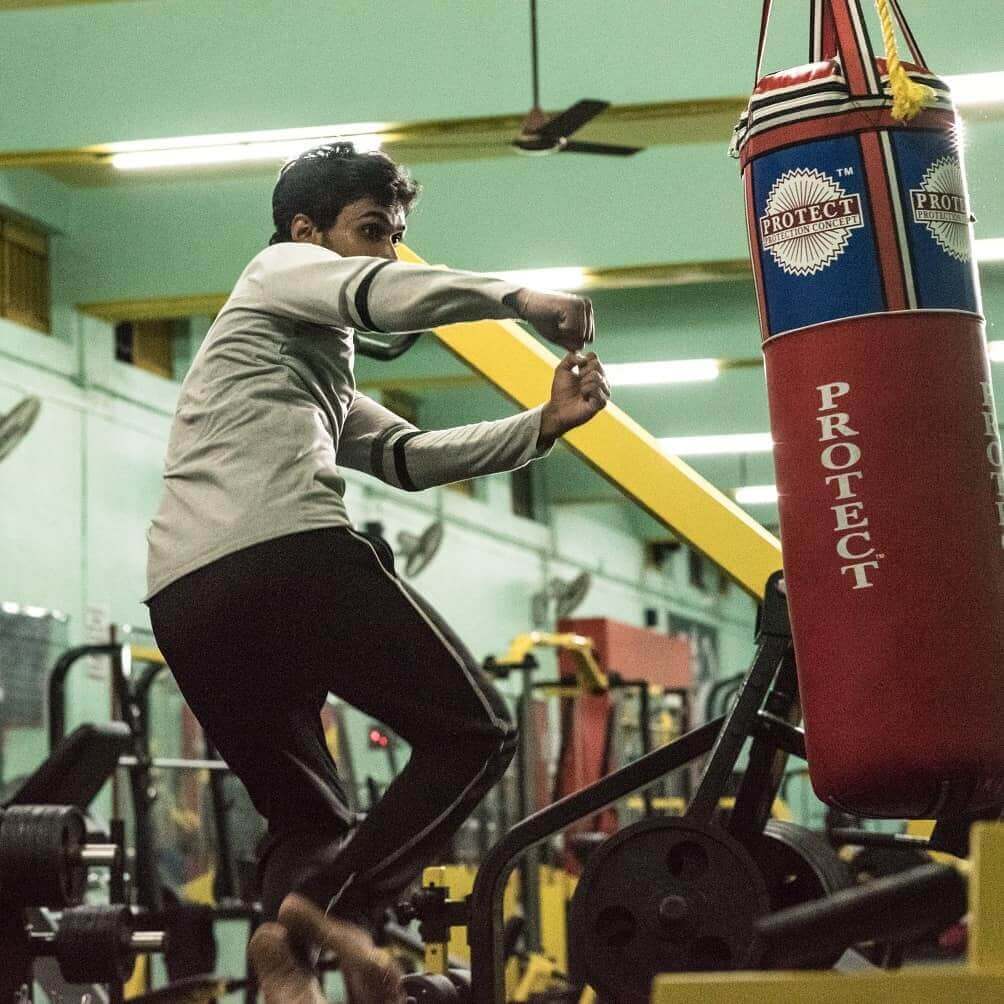 Person lifting weights at the gym, building strength and muscle