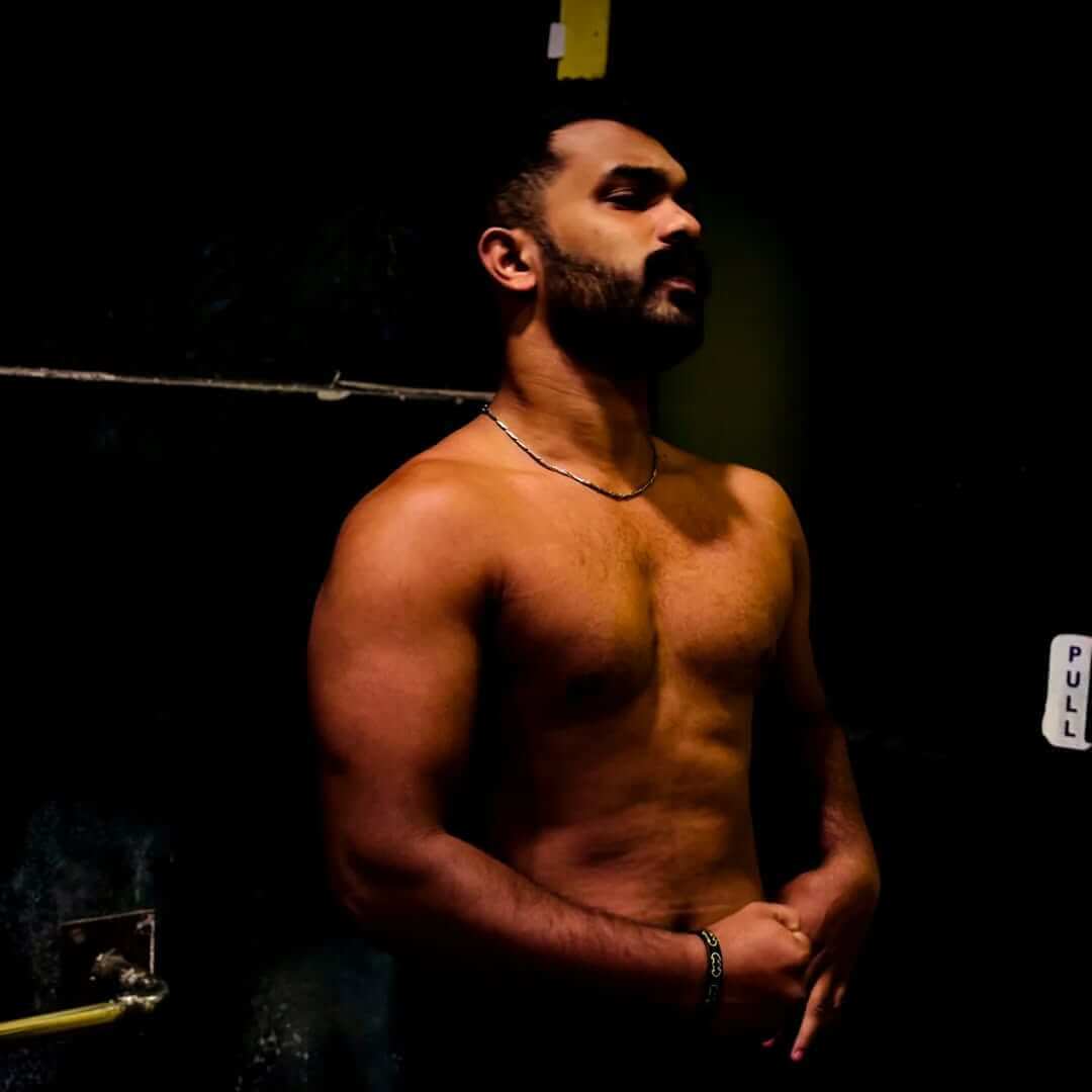 Bodybuilder with defined muscles in a gym