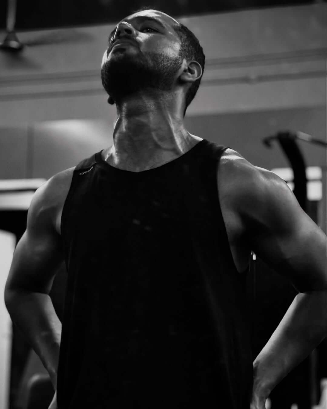 Bodybuilder with defined muscles in a gym