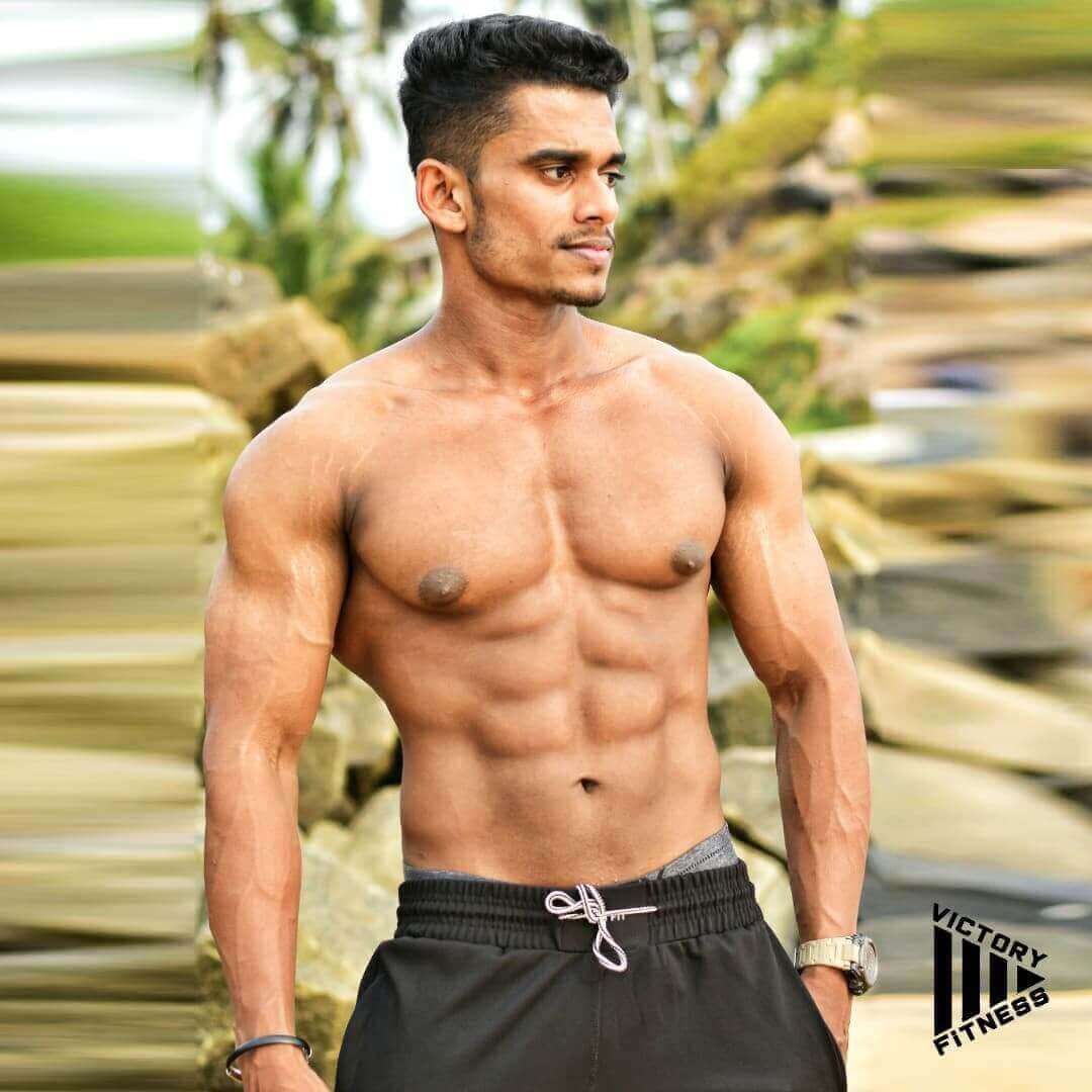 Bodybuilder with defined muscles in a gym