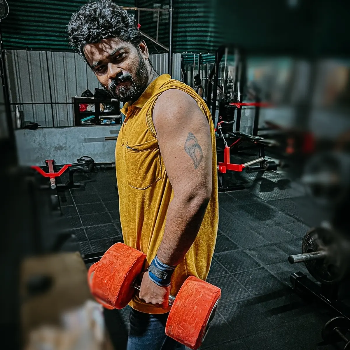Bodybuilder with defined muscles in a gym