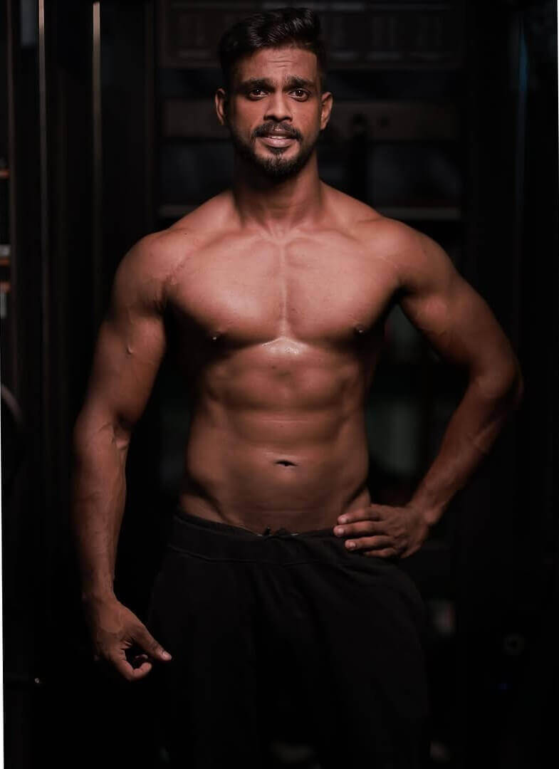 Bodybuilder with defined muscles in a gym
