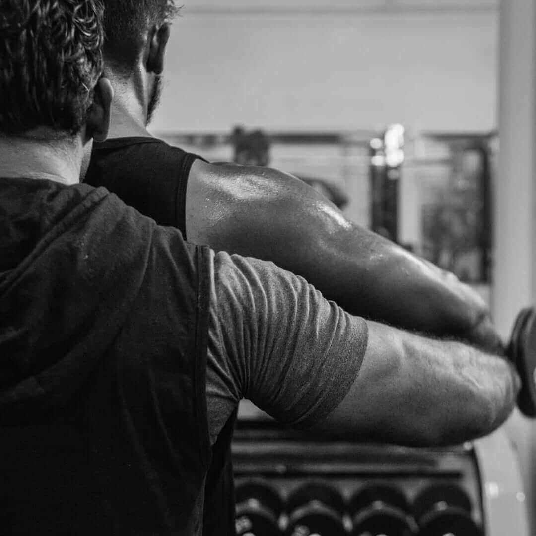 Bodybuilder with defined muscles in a gym