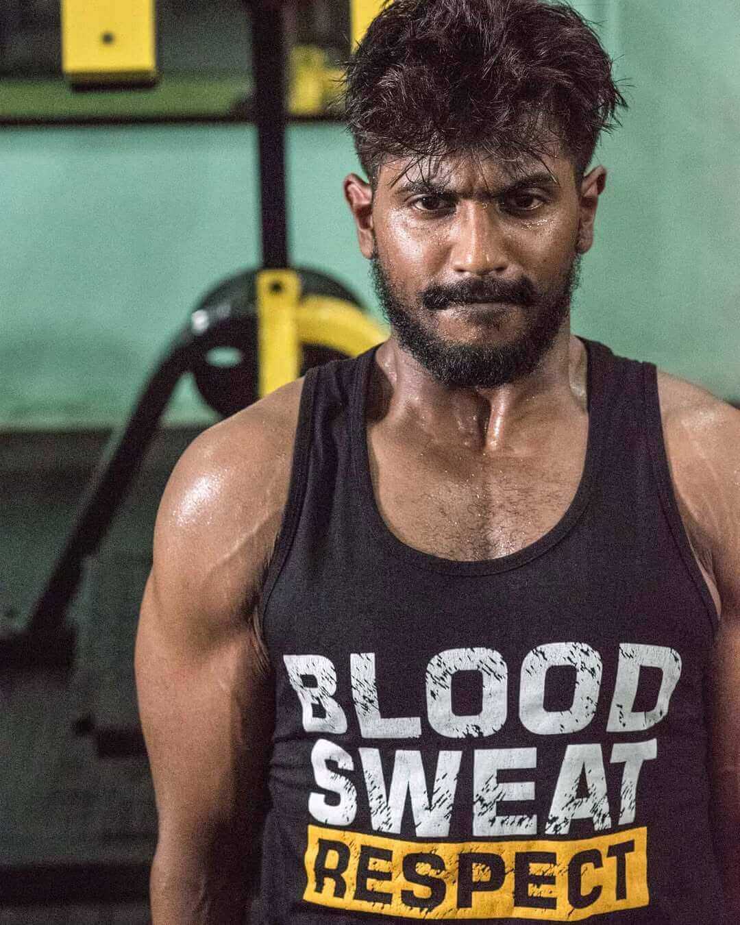 Bodybuilder with defined muscles in a gym