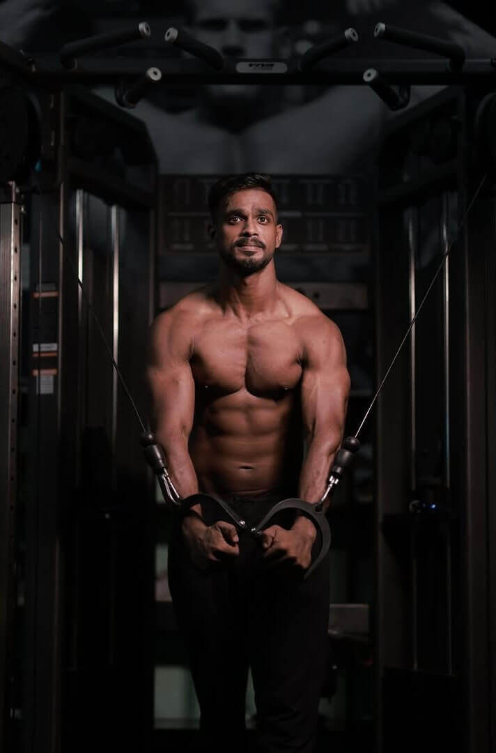 Bodybuilder with defined muscles in a gym