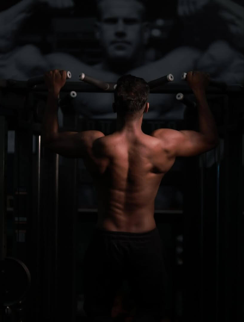 Bodybuilder with defined muscles in a gym