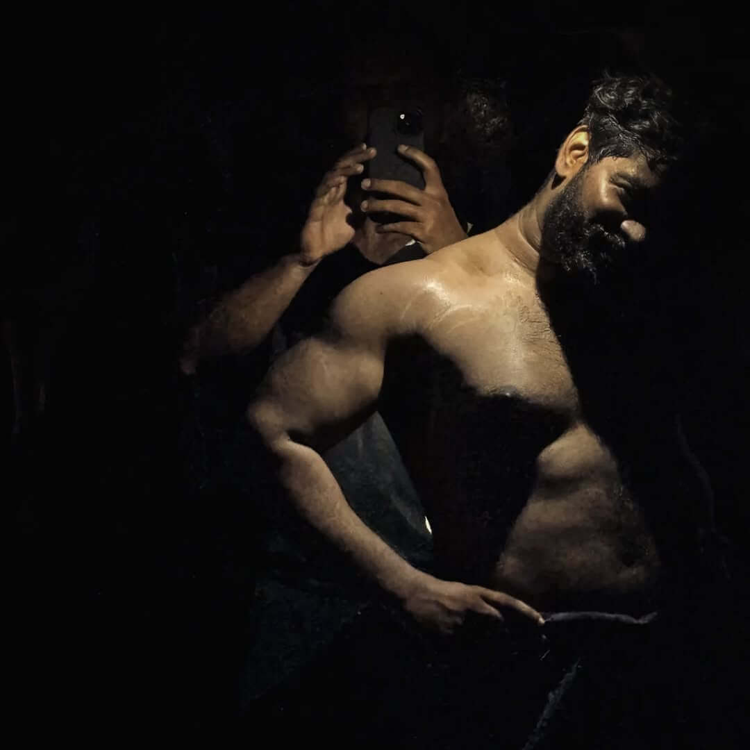 Bodybuilder with defined muscles in a gym