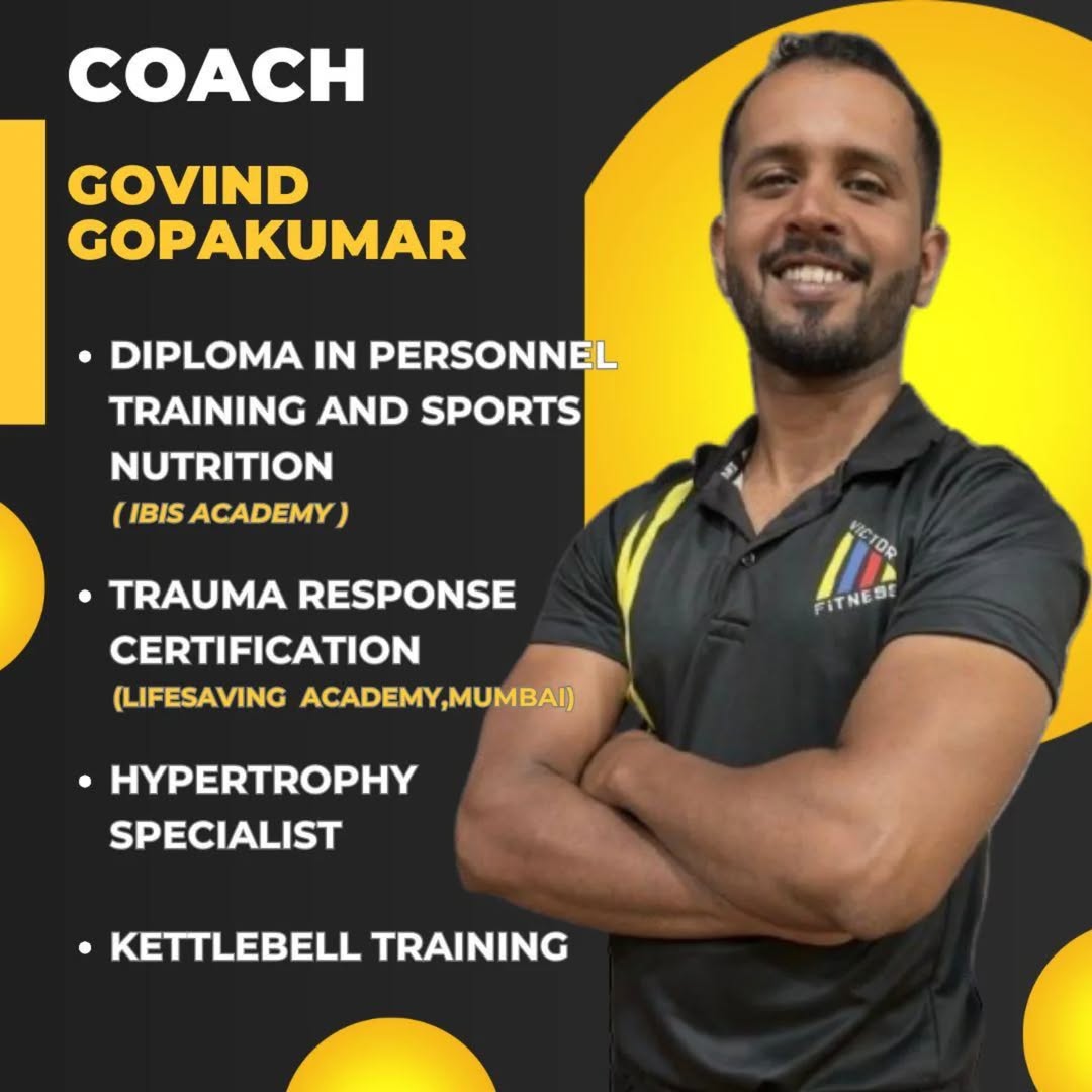 Certified personal trainer with a strong physique standing in the gym